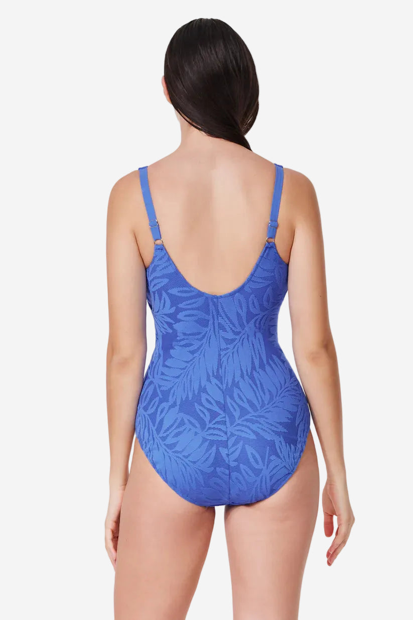 Blue leaf-patterned swimsuit worn by a model on a white background