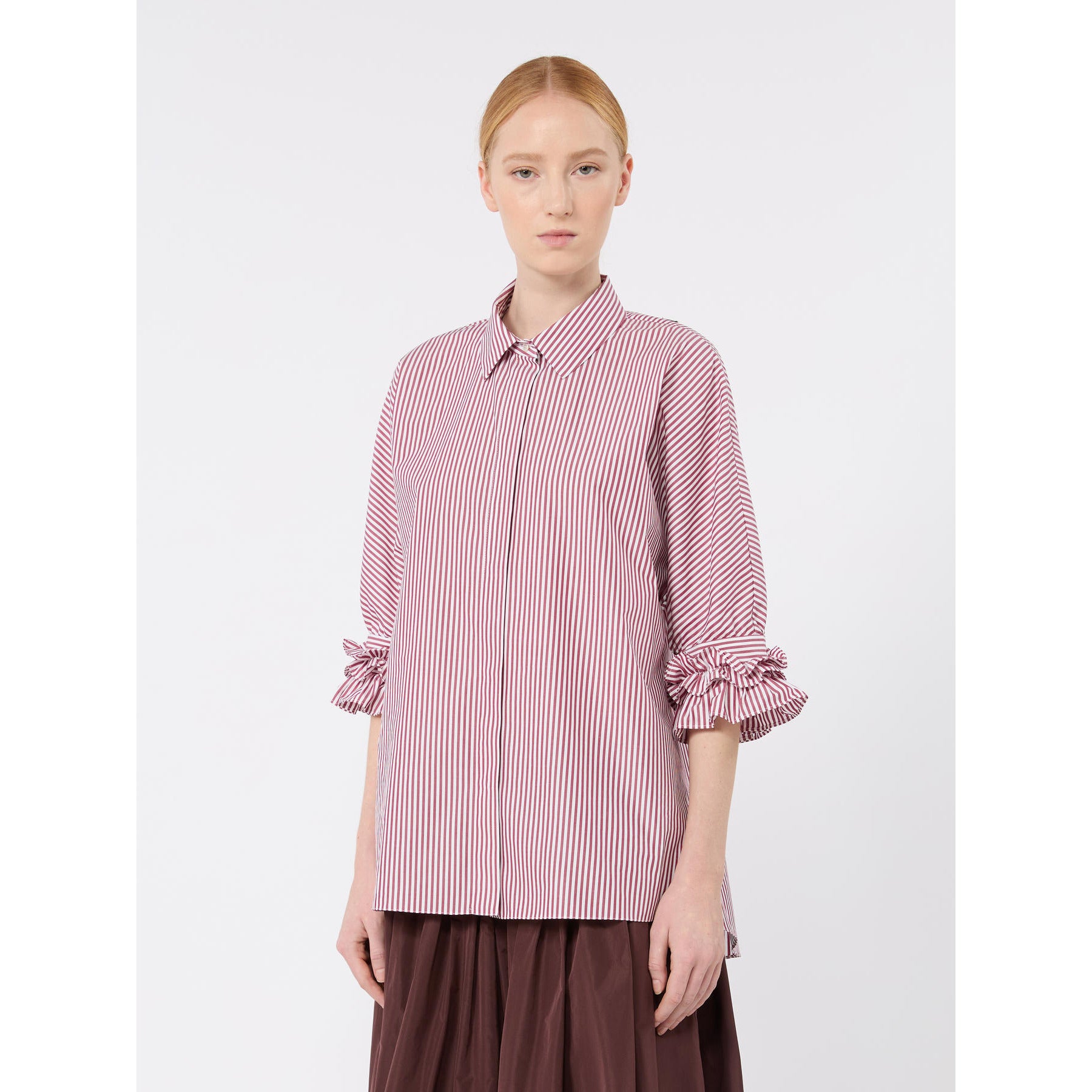 Woman wearing a pink and white striped shirt on a white background