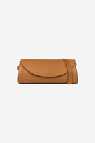 Tan clutch bag on a white background