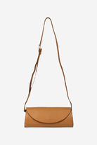 Tan leather handbag with a strap on a white background