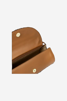 Brown leather clutch bag with gold hardware on a white background