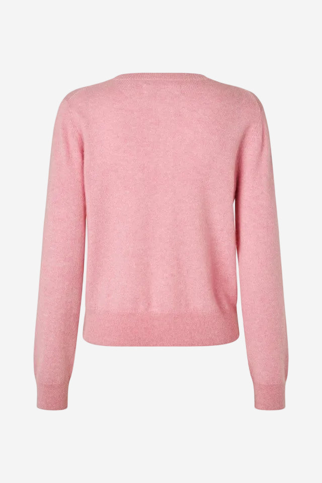 Pink sweater on a white background