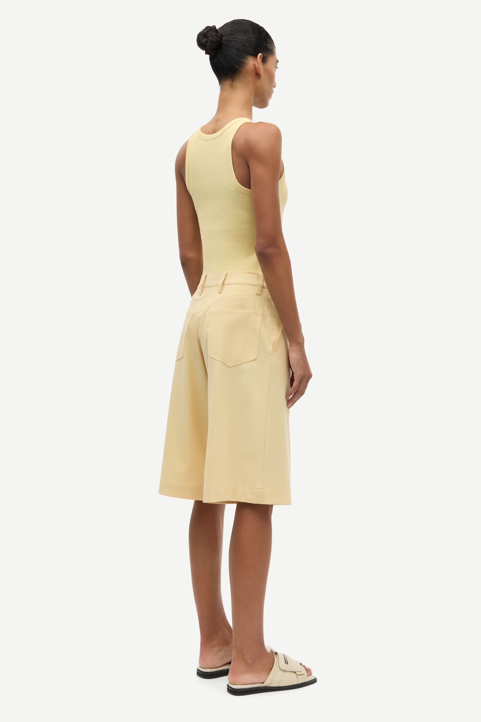 Woman wearing a yellow dress on a white background