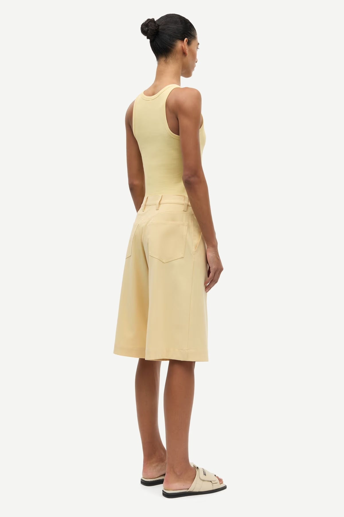 Woman wearing a yellow dress on a white background