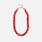 Red beaded necklace with a gold clasp on a white background