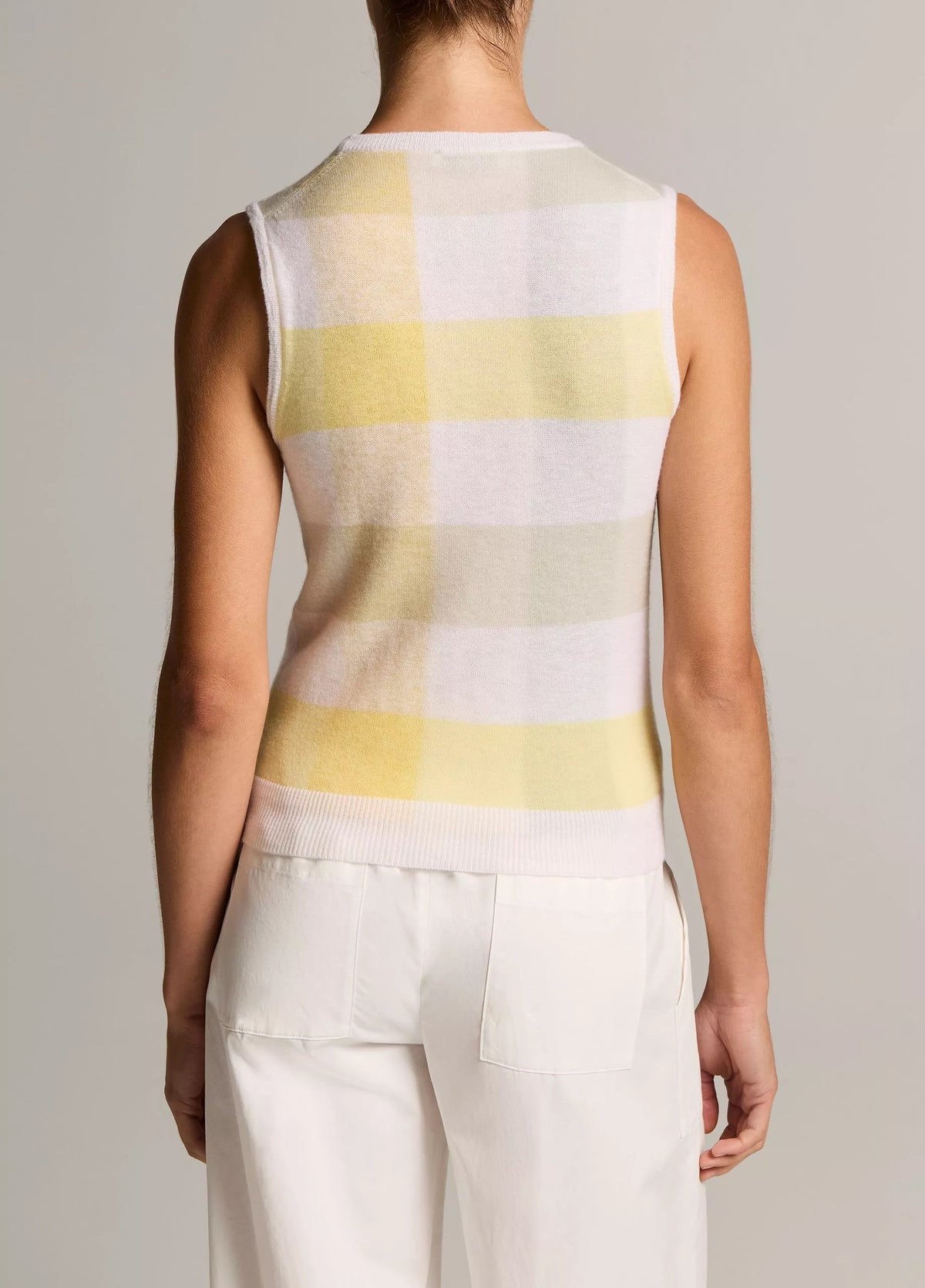 Model wears plaid tank with white pants