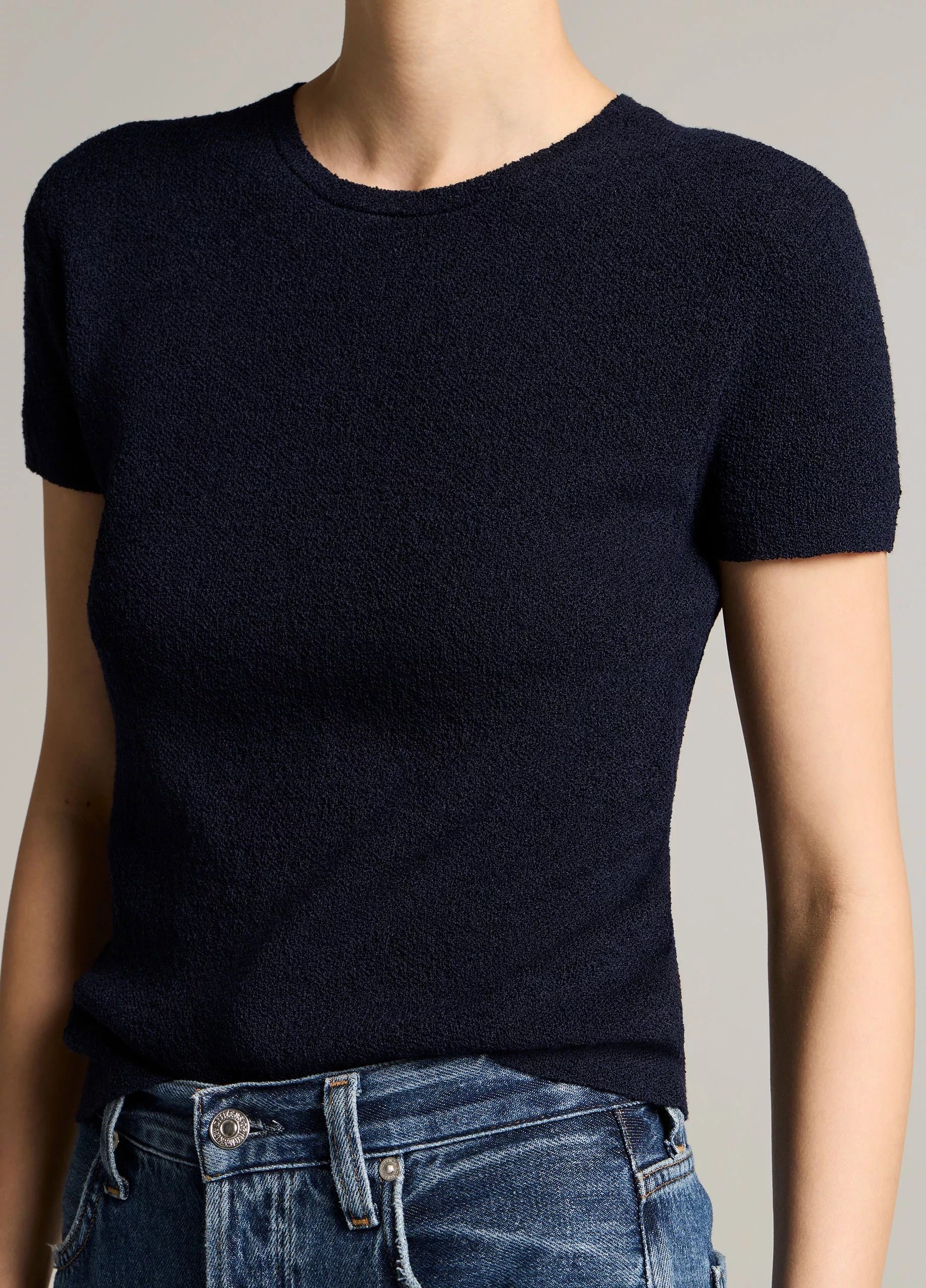 Woman wears a navy crew and jeans