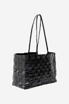 Black woven handbag on a white background
