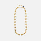 Gold necklace with a blue bead on a white background
