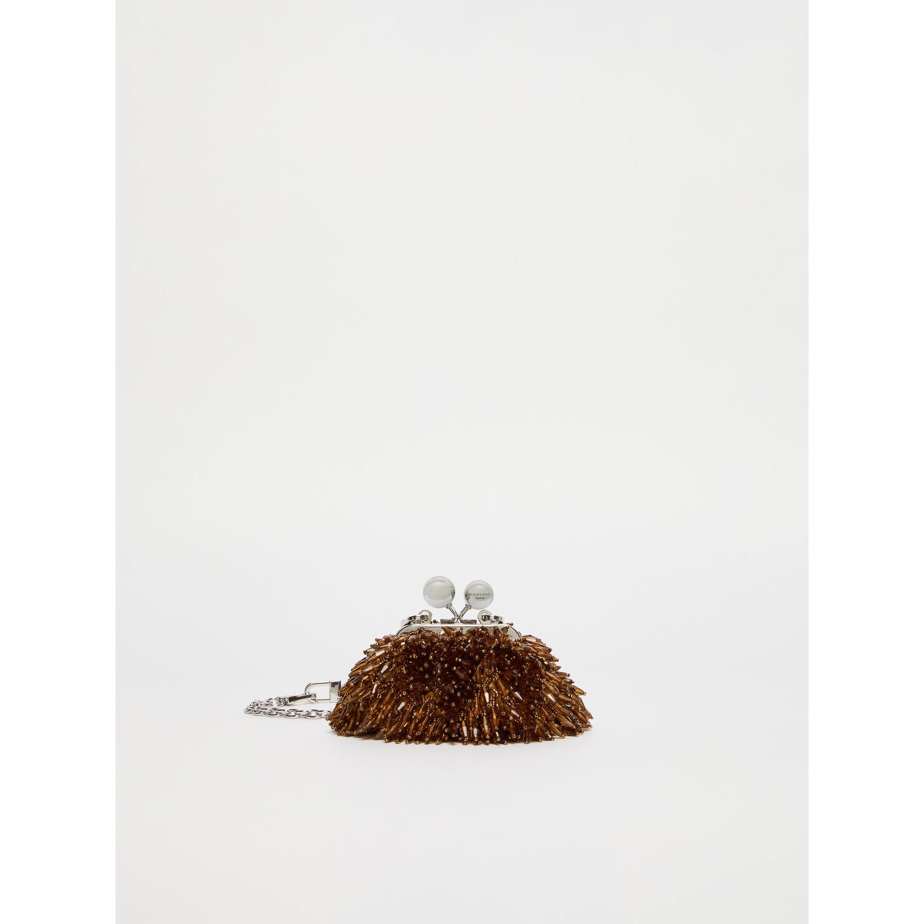 Small brown handbag with decorative elements on a white background