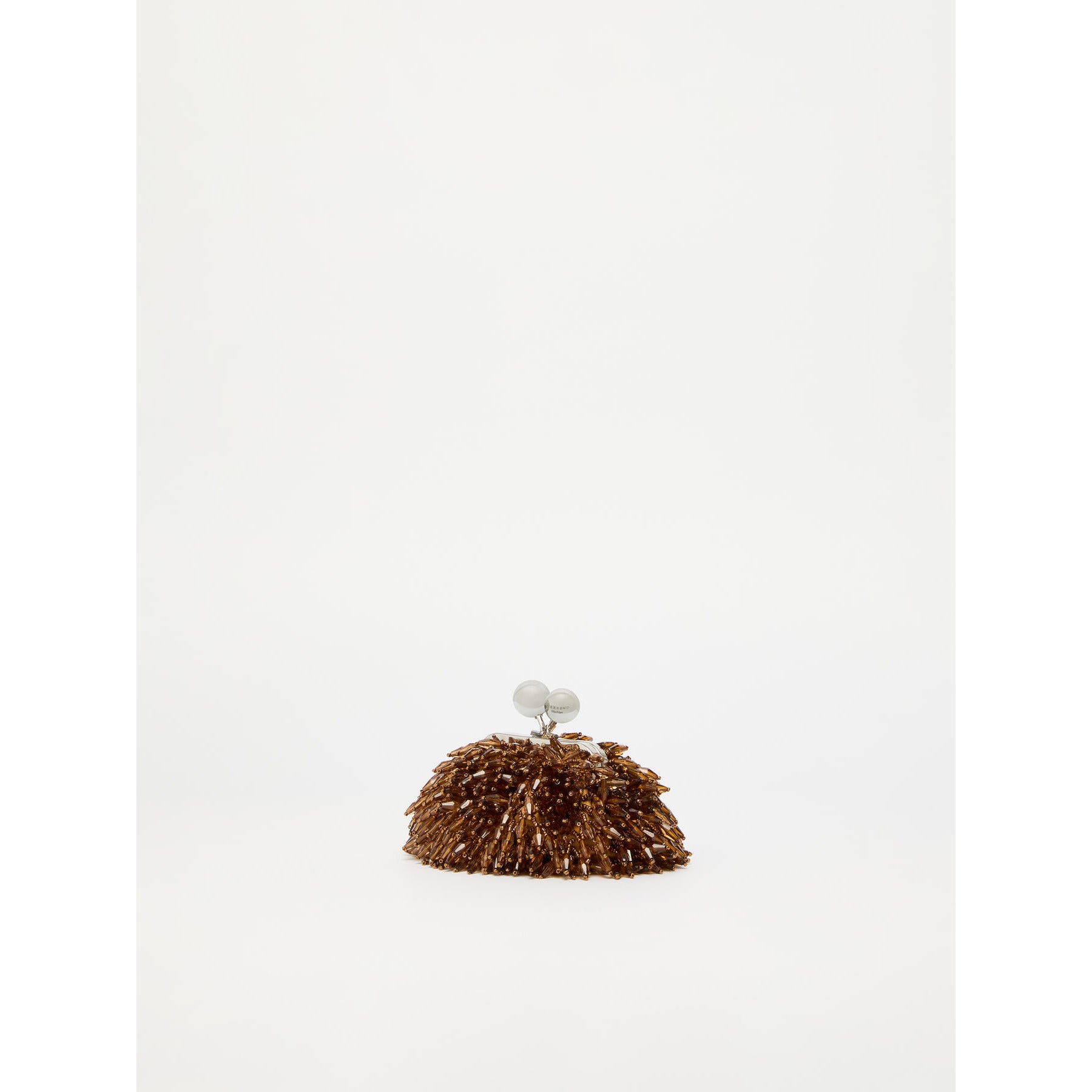 Brown textured object with a spherical element on a white background
