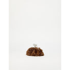 Brown textured object with a spherical element on a white background