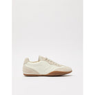 White sneaker with brown sole on a white background