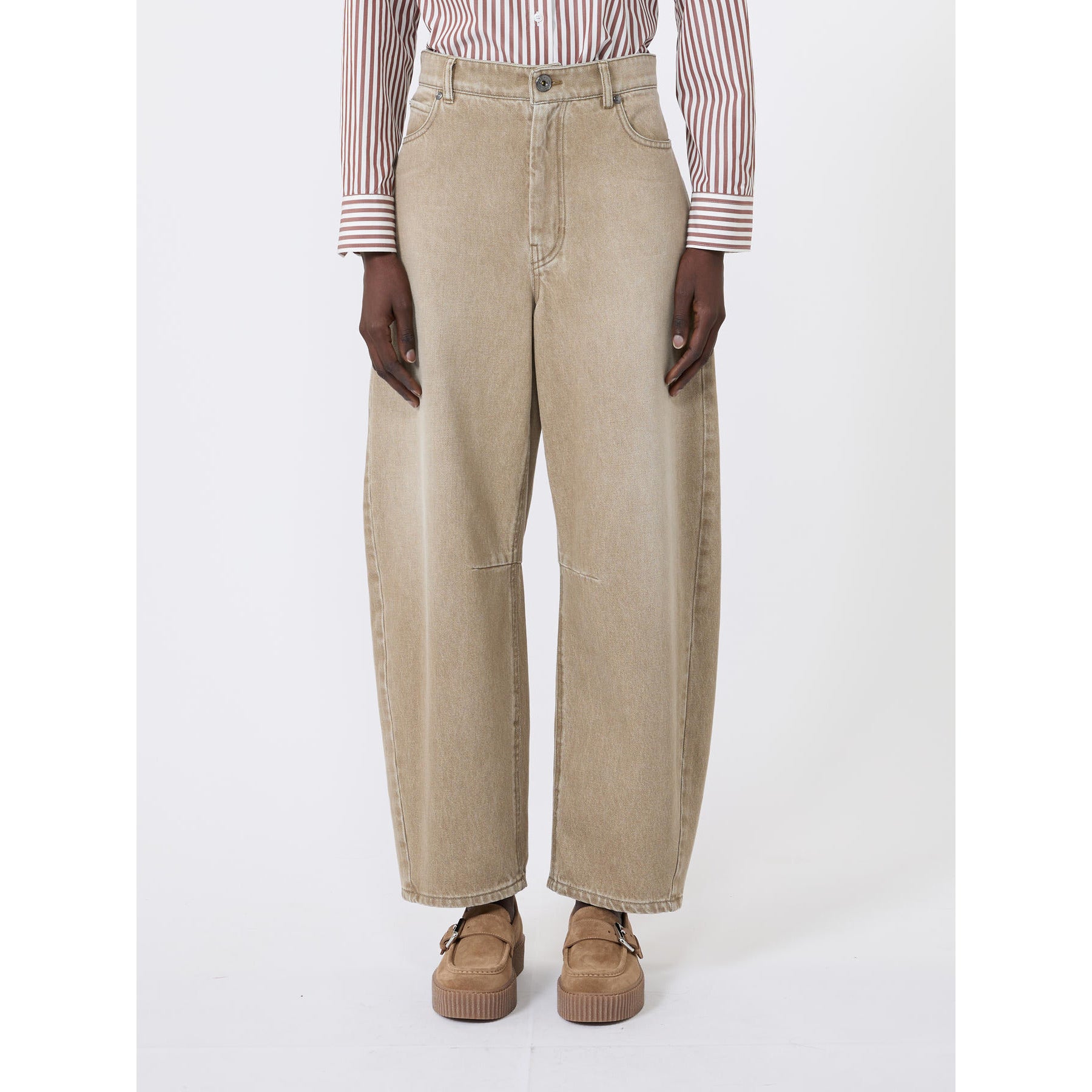 Person wearing beige wide-leg jeans and a striped shirt on a white background