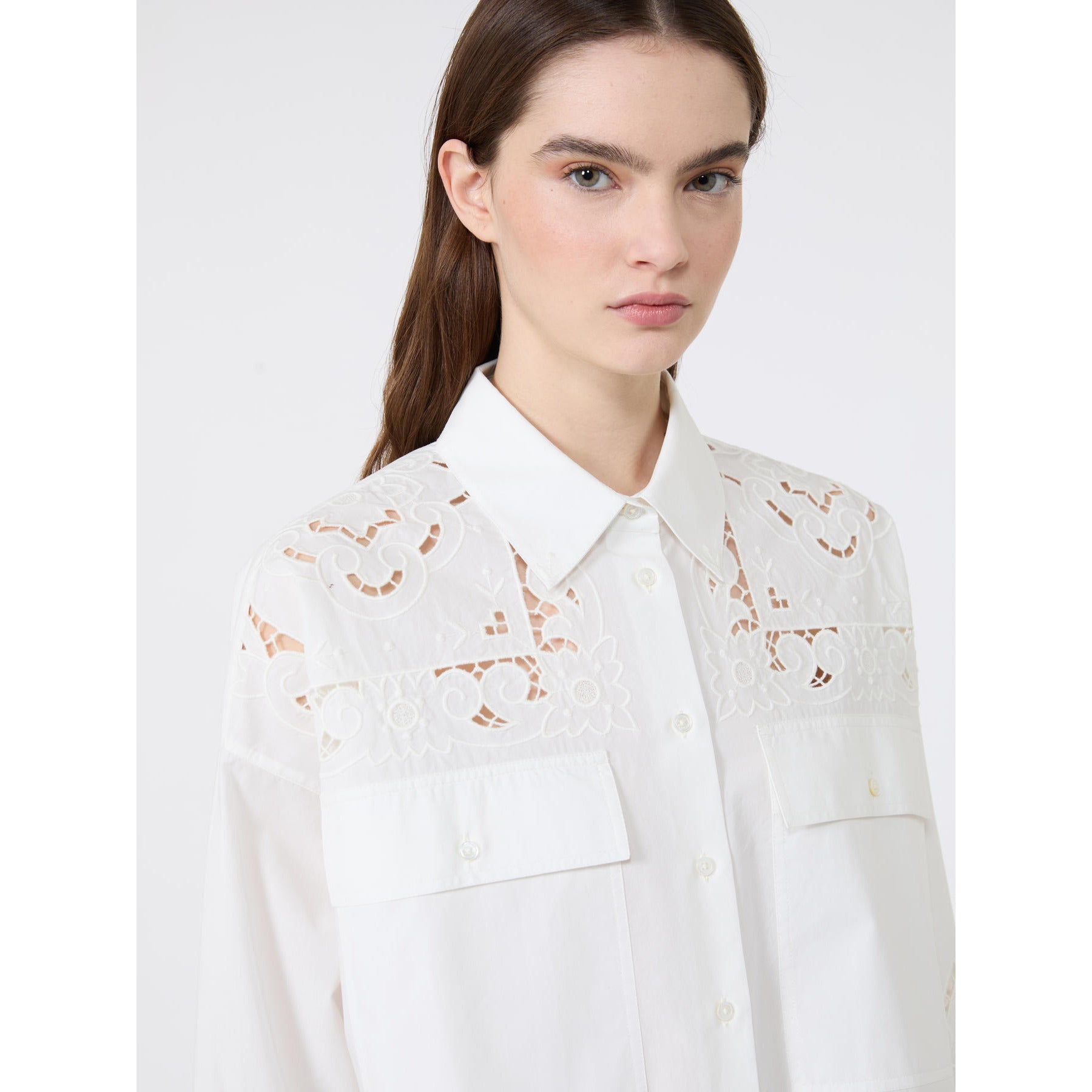White blouse with lace details on a white background