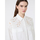 White blouse with lace details on a white background