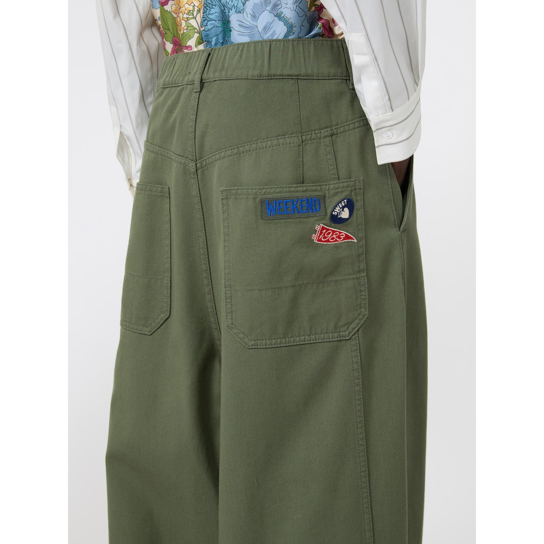 Green pants with patches on a white background