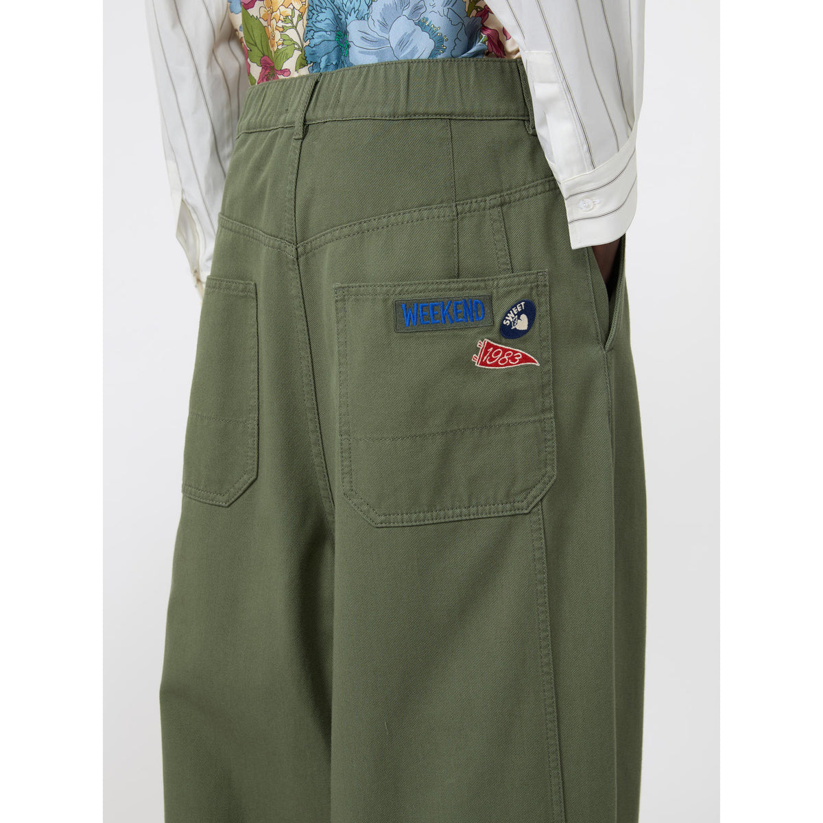Green pants with patches on a white background