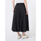 Person wearing a black skirt on a white background