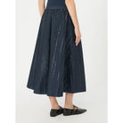 Navy pleated skirt worn by a person on a white background