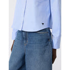 Light blue shirt and blue jeans on a white background