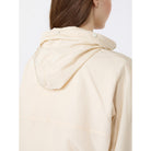 Beige raincoat worn by a person on a white background