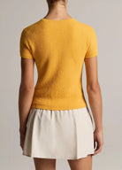 women wears beige skirt and yellow Tshirt by Vince