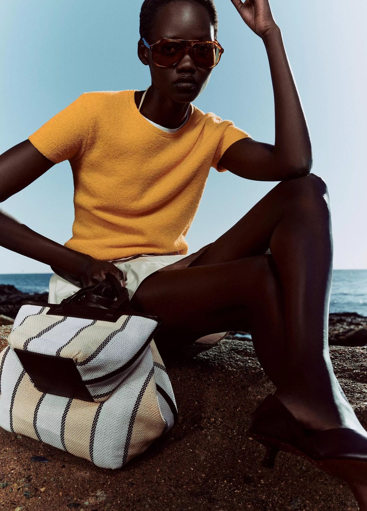 women wears beige skirt and yellow Tshirt by Vince