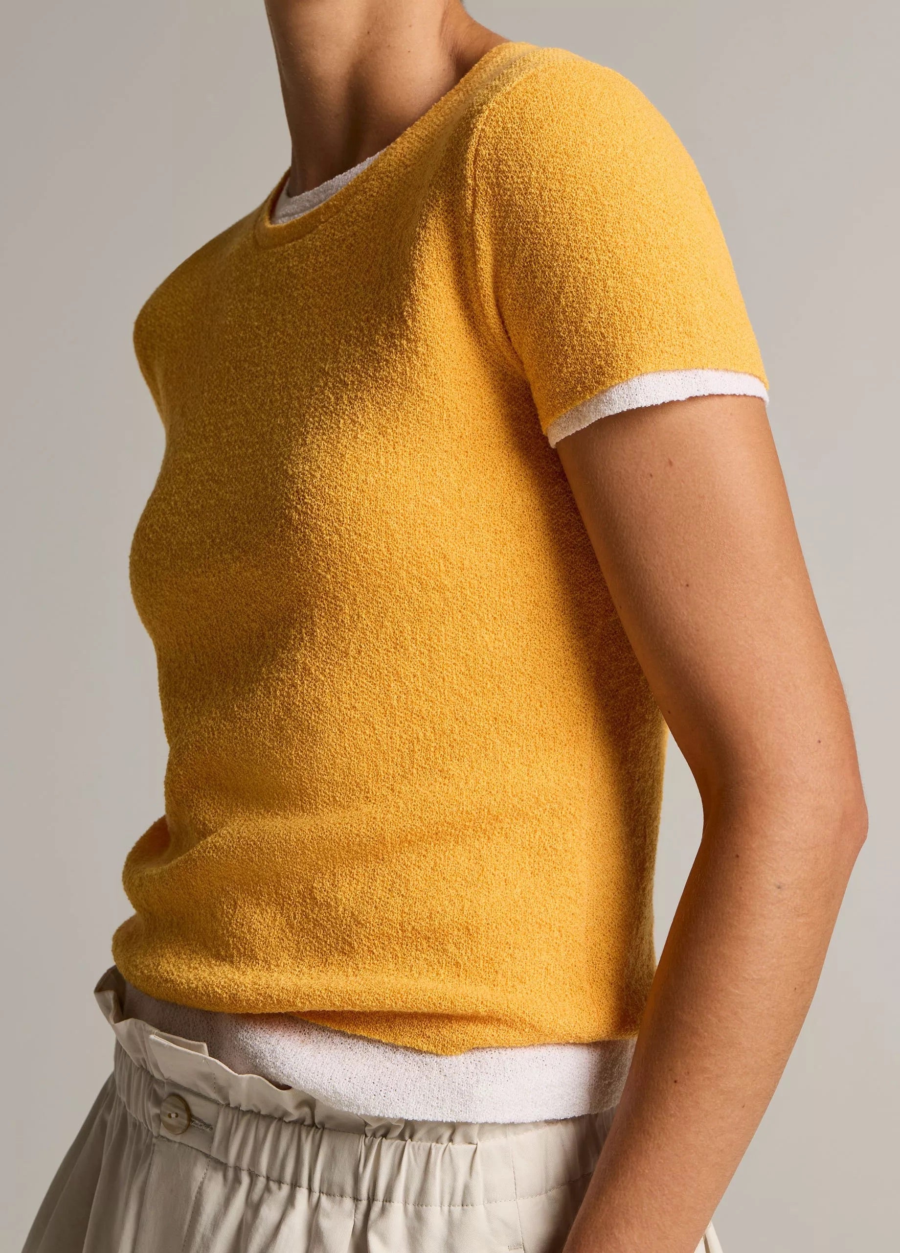women wears beige skirt and yellow Tshirt by Vince