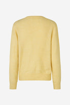 Yellow sweater on a light gray background