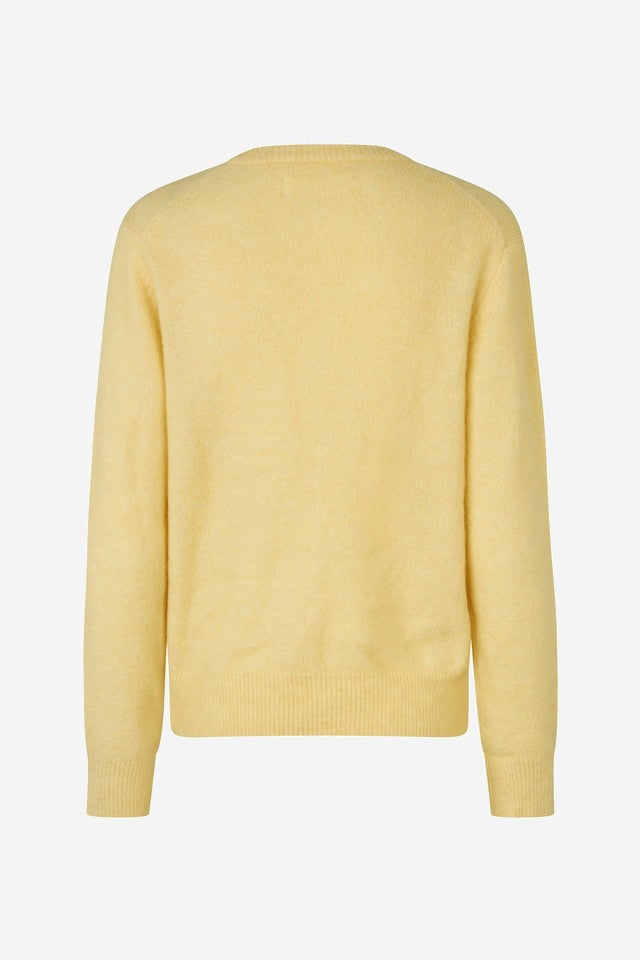 Yellow sweater on a light gray background
