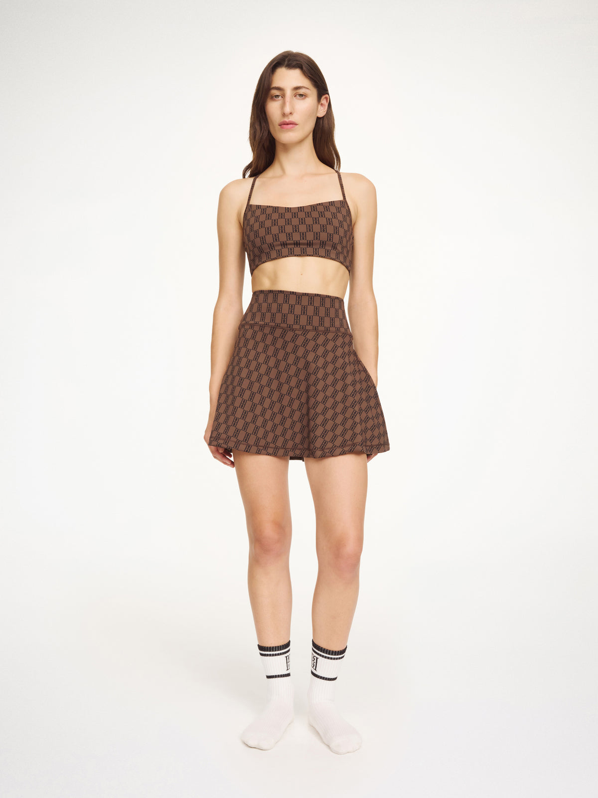 Woman wearing a brown checkered outfit on a white background