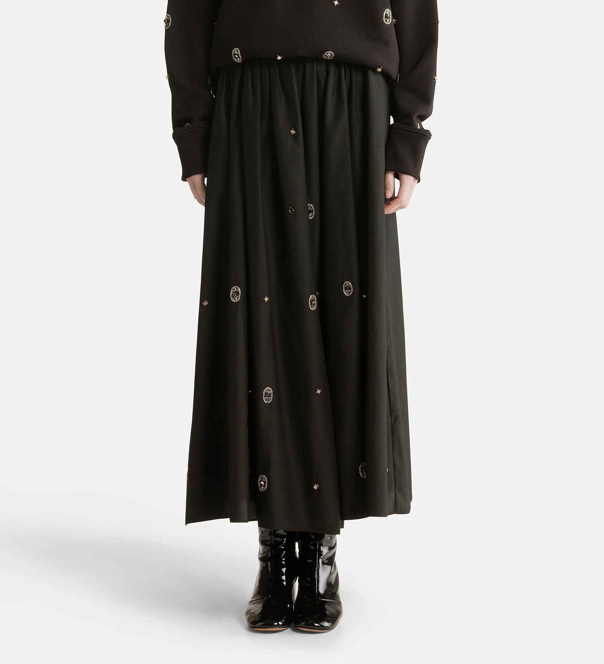 Black long skirt with button details on a white background