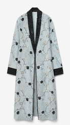 A light blue jacquard robe with black and beige floral embroidery, featuring a black patterned shawl collar, cuffs, and front closure, shown against a plain white background.
