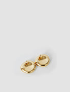 Pair of gold hoop earrings on a light gray background
