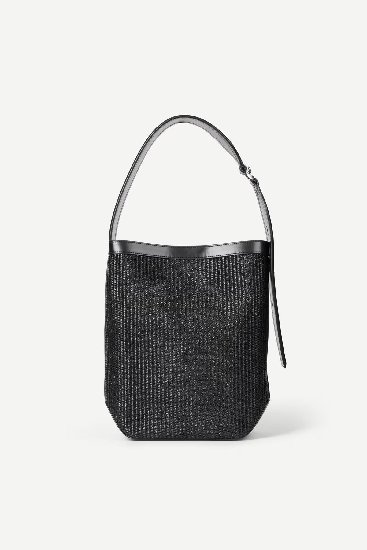 Black woven handbag with silver handle on a white background