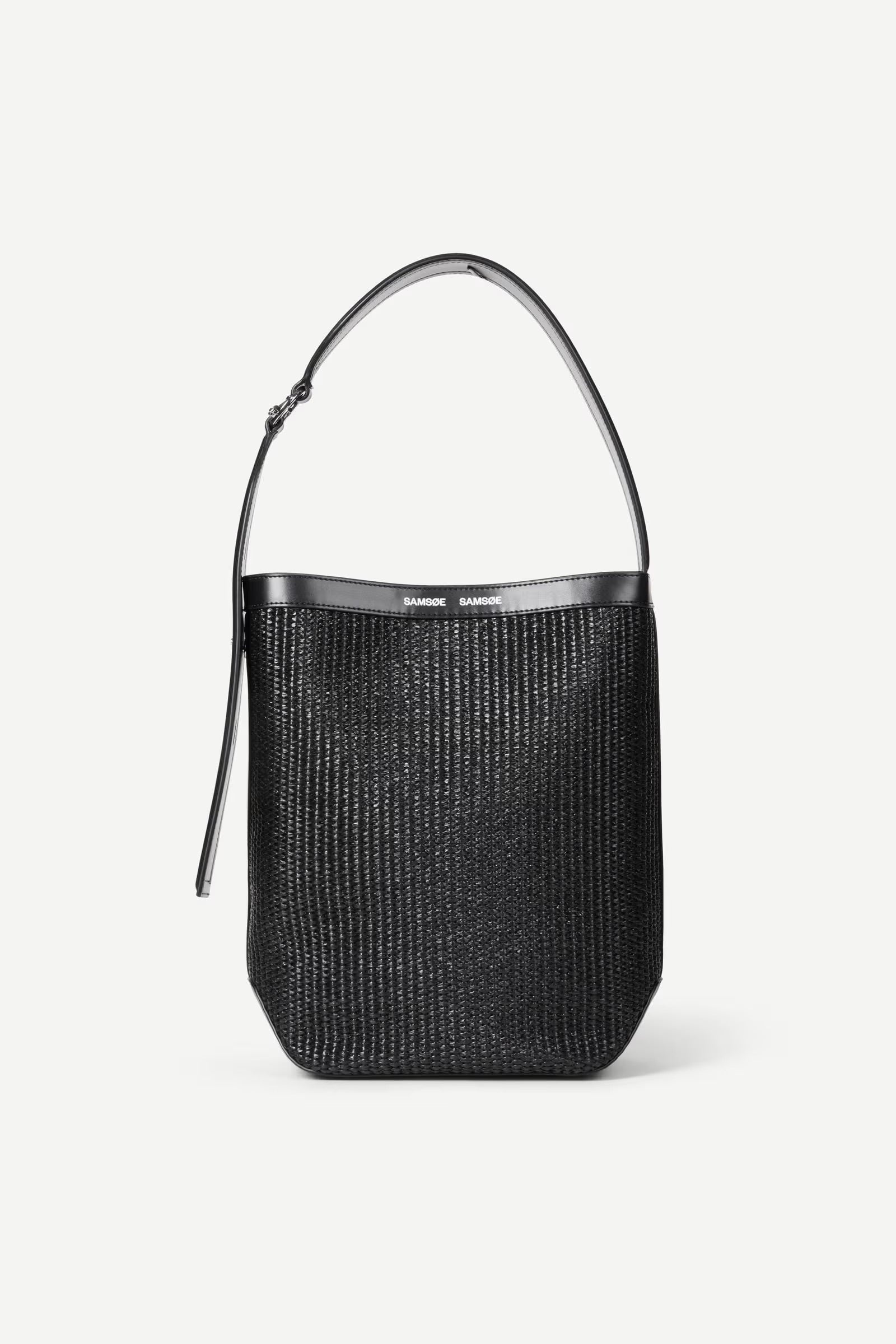 Black woven handbag with a metallic handle on a white background