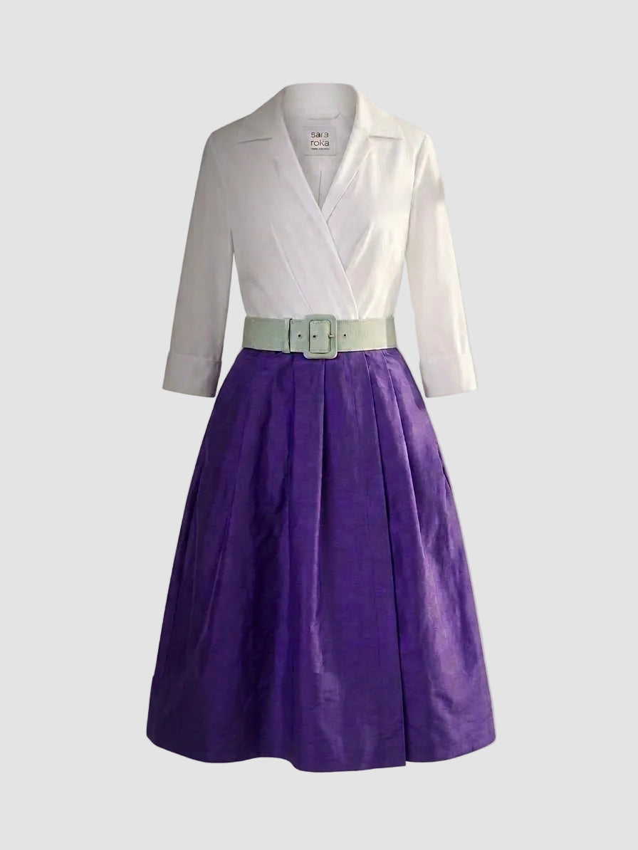 White blouse with gray sleeves and a purple skirt on a light gray background